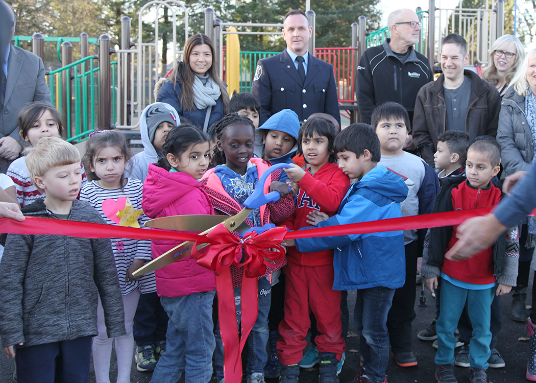 WE Kinvig playground kids cutting ribbon.jpg